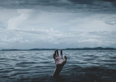 PTSD hand in ocean reaching above water